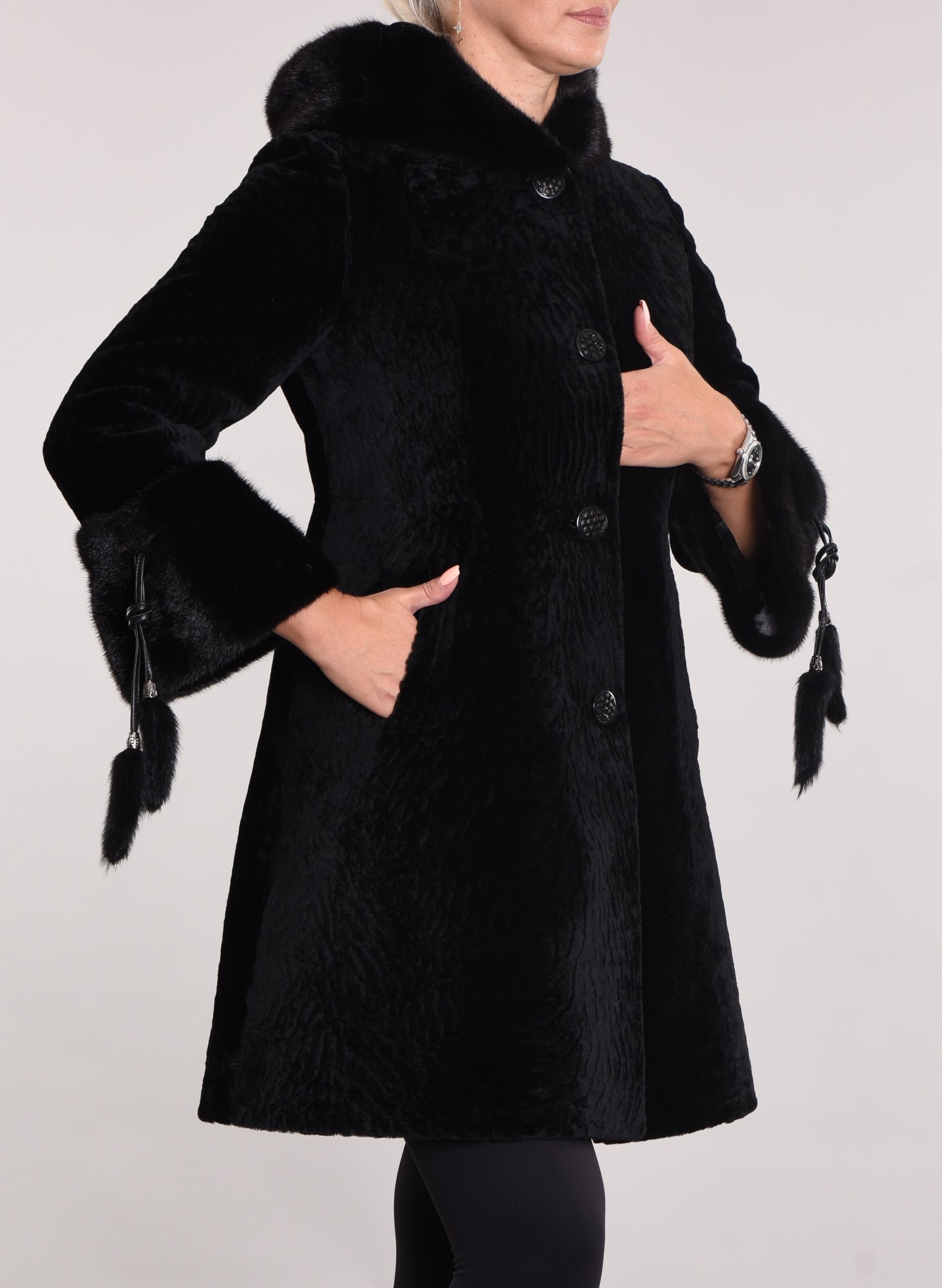 Astragan on the lining. Mink cuff and hood